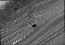 North polar layered deposits of ice and dust. Conical mound in trough on Mars' north pole.jpg