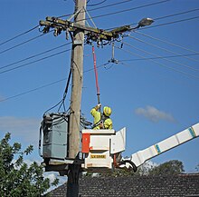 A linesman working for Country Energy in Australia closing a circuit using a hot stick Country Energy linesmen closing the circuit.jpg