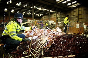 British police officers checking for stolen metal at a scrap metal merchant Day 56 - West Midlands Police tackling metal theft.jpg