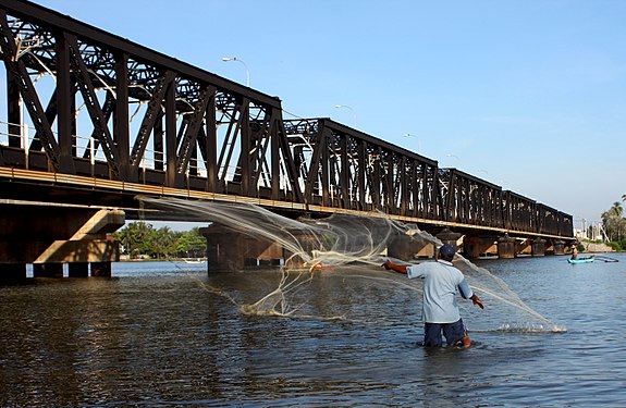 Fishing on a lagoon by net throwing near Kallady Bridge, Batticaloa, Sri Lanka.