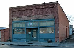 Photograph of the Green Lantern Saloon, a single-story, brick commercial building on a city street