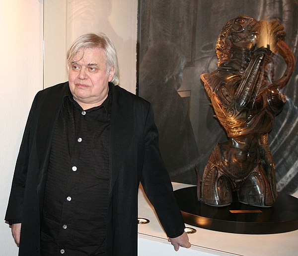 H. R. Giger with a Sil sculpture.