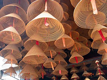 Incense coils hanging from the ceiling of an East Asian temple