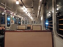 Interior of a CAF-GEE train from Line E. Interior of a CAF-General Electrica Espanola from the Buenos Aires Metro (33531190080).jpg