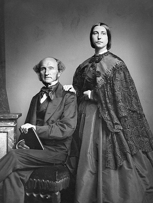 John Stuart Mill and Helen Taylor. Helen was the daughter of Harriet Taylor and collaborated with Mill for fifteen years after her mother's death in 1858.