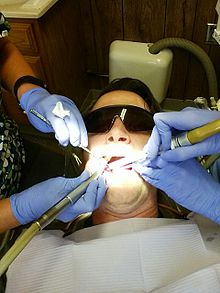 A man being treated by a dental team Man At Dentist.JPG