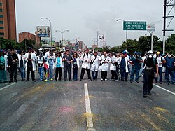 Medics hold arms during the Health March on 24 May. Medic Protesters Venezuela 2017.jpg