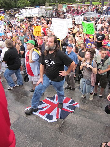 American protester stands on a Union Flag, presumably associating BP with the United Kingdom