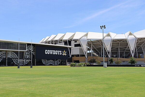 The facade of the Cowboys' training and administration base, with Queensland Country Bank Stadium in the background.