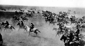 A black-and-white photograph of cowboys on their horses