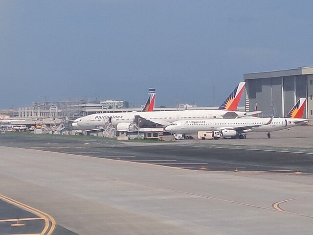 Aircraft of Philippine Airlines parked next to the maintenance hangars of Lufthansa Technik Philippines