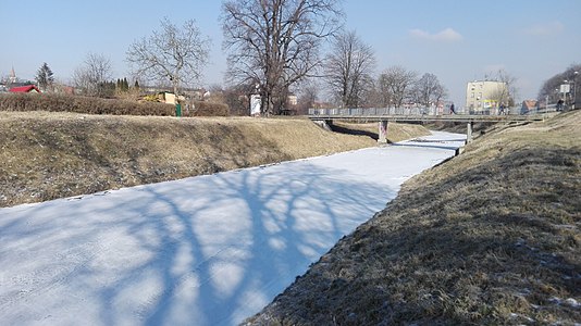 A sunny day with frozen river Prudnik in Poland 1. March