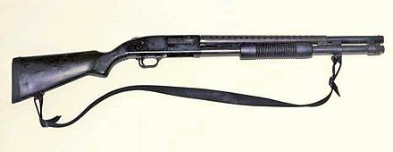 The Mossberg 590 pump action shotgun with the barrel over the tubular magazine.