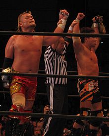 Tencozy as the NWA World Tag Team Champions in June 2014. TENKOJI NWA World Heavyweight Tag Team Champions.JPG