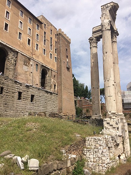 The repurposed ruins of the Tabularium (behind the fragmentary ruins of the Temple of Vespasian and Titus at right) constructed in 78 BC near the aerarium as the state record office.[31]