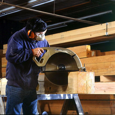 An unusually large hand-held circular saw for cutting timbers with a roughly 16 in (410 mm) blade.