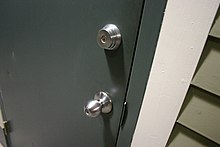 Door with two locks, one in the doorknob and a separate deadbolt Two holes no waiting.JPG