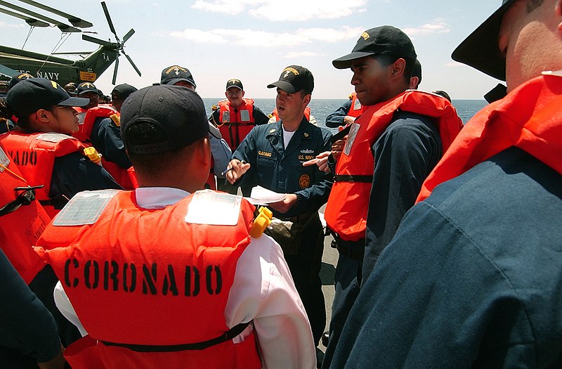 File:US Navy 040429-N-9849W-011 During an abandon ship drill aboard USS Coronado (AGF 11), Chief Master-at-Arms Vic Glaviano, from New Orleans, La. explains to crewmembers assigned to his life raft how to survive in the water.jpg