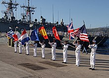 US Navy 050520-N-0780F-008 Storekeeper First Class Lonnie Campton, assigned to USS Taylor (FFG 50), serves as color guard for the American flag during the opening ceremony of the North Atlantic Council (NAC) and the Military Co.jpg