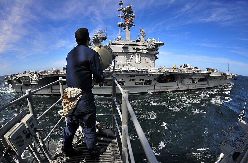 File:US Navy 100311-N-4774B-153 Quartermaster Seaman Matthew Rivera, from Mount Bethel, Penn., signals to Sailors aboard the aircraft carrier USS Carl Vinson.jpg