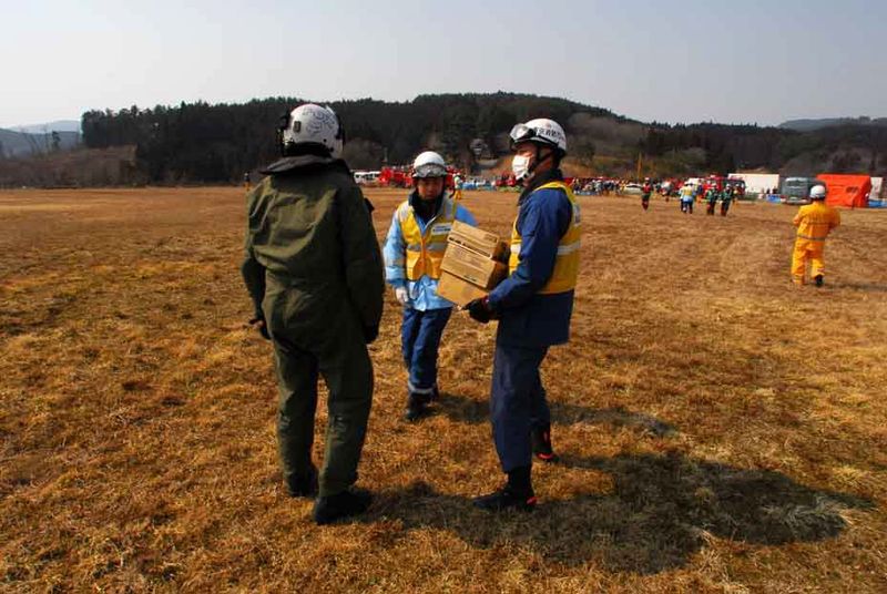 File:US Navy 110313-N-SB672-001 Naval Air Crewman 2nd Class Brian Fox delivers supplies to Japanese aid workers during earthquake and tsunami relief eff.jpg