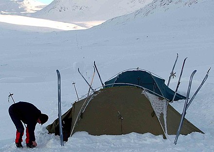 Skis and ski poles used to secure the tents in the snow. Kungsleden trail in winter.