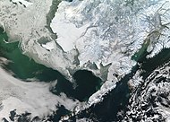 جزیره کودیاک در جنوب شبه جزیره آلاسکا در سمت راست در نزدیکی ساحل شبه جزیره آلاسکا با ساحلی چین و شکنج‌دار دیده می‌شود.