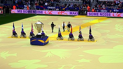 The Wheelchair trophy being brought out at the 2021 Rugby League Cup opening ceremony for all three tournaments 2021 Rugby League World Cup opening - Wheelchair trophy.jpg