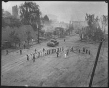Pershing tanks in downtown Seoul during the Second Battle of Seoul in September 1950. In the foreground, United Nations troops round up North Korean prisoners-of-war. A U.S. Marine tank follows a line of prisoners of war down a village street. - NARA - 532408.tif