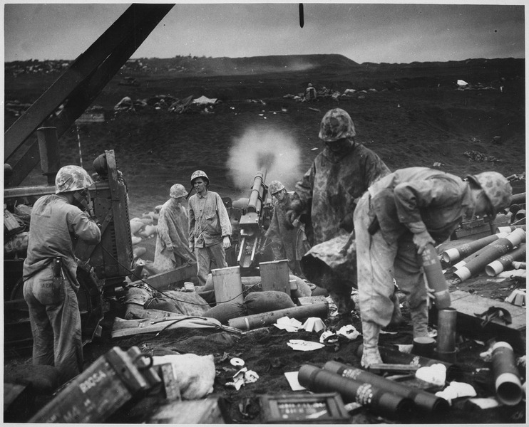File:Across the litter on Iwo Jima's black sands, Marines of the 4th Division shell Japanese positions cleverly concealed... - NARA - 513219.tif