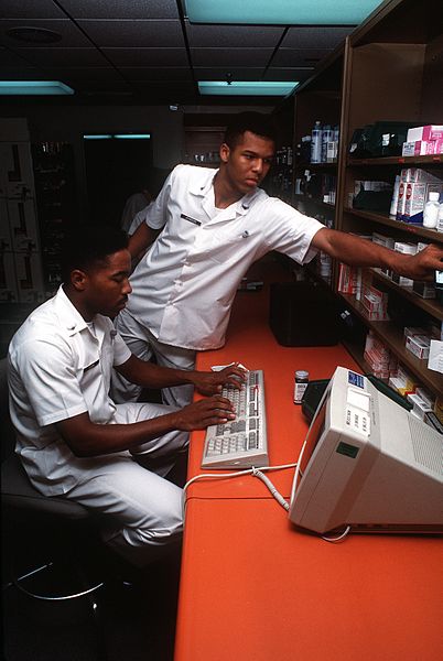 File:Airman first Class (A1C) George Brown, left, and A1C Kevin Johnson, pharmacy technicians, fill prescriptions using the Composite Health Care System (CHCS), a computer network that links various medical F-3006-SPT-93-000001-XX-0049.jpg