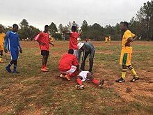 For most sports, injuries are more likely to happen during games than during practice. An injured player lying down during a soccer game. Cosmo City, South Africa.jpg