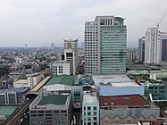 The Gateway Tower and buildings along Aurora Boulevard and Araneta City in the background.