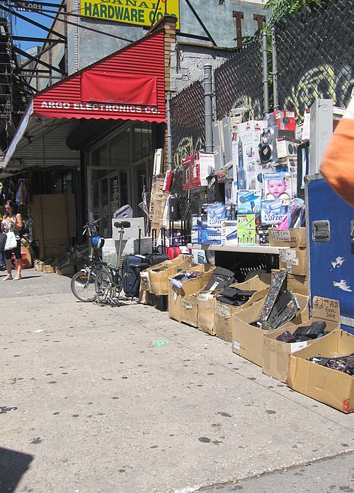 Sidewalk bins of a defunct shop at 393 Canal Street