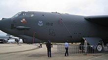 Buckled skin panels on a B-52 aircraft. Thin skin panels buckle at very low loads. In the case shown here, the weight of the forward fuselage structure ahead of the nose undercarriage is sufficient to cause the panels to buckle. Buckled panels are still effective in carrying shear by diagonal tension. B52-buckling.jpg