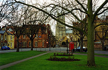 Barton Square, Ely, with school buildings surrounding it at the front and to the right. Ely Cathedral is in the distance. Barton Square.jpg