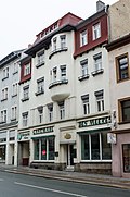 Residential house with shop fitting, in closed development