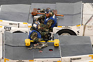 Blueshirts move, chock and chain aircraft at the direction of Yellowshirts.