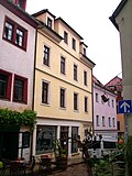 Residential house in closed development and side wing in the courtyard