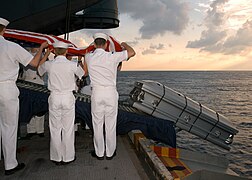 Flag is removed from coffin before burial