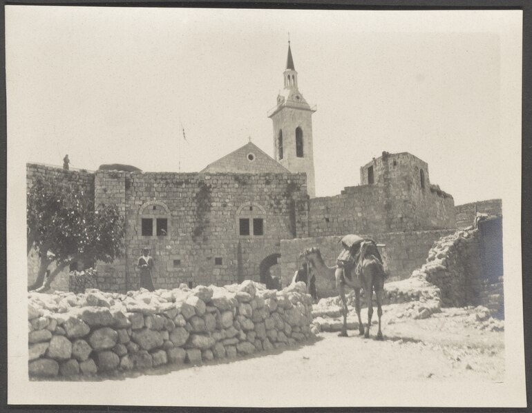 File:Church of Saint John the Baptist seen from the front with its tower, a camel and people standing in front of the church, NINO F Scholten photographic print 02 0064.tiff