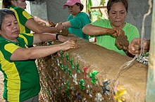 Women in the Philippines use cob and ecobricks to create a wall. Inside the cob, the plastic is indefinitely secured from degradation for the long term. Eventually, when the wall comes to its end, the ecobricks can be extricated and reused for another construction