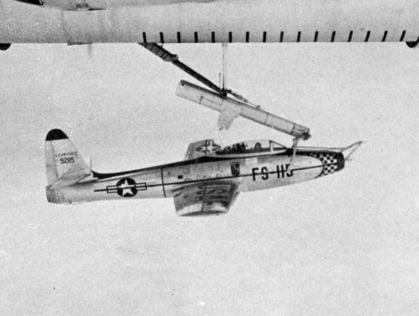 An F-84 Thunderjet hooked on a FICON trapeze beneath its mother ship