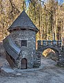 English: Spillway tower at the castle pond and pointed arch portal with merlons Deutsch: Wasserablauf-Schleusenturm am Schlossteich und zinnenbewehrter Torbogen