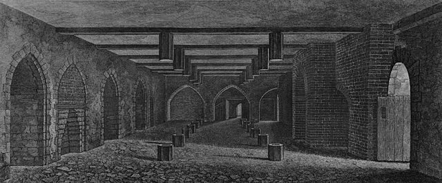 A monochrome illustration of a stone and brick-walled room. An open doorway is to the right. The left wall contains equally spaced arches. The right wall is dominated by a large brick arch. Three arches form the third wall, in the distance. The floor and ceiling is interrupted by regularly spaced hexagonal wooden posts. The ceiling is spaced by wooden beams.