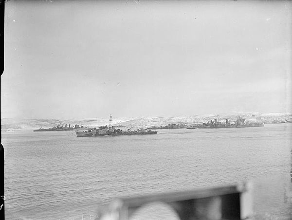 In the distance HMS Obdurate (centre) leaving a Russian bay, with HMS Cumberland (left) and HMS Belfast (right) with HMS Faulknor alongside. Photograp