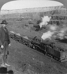 An open-cast iron mining industrial railway in Hibbing, Minnesota, circa 1906.