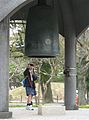 A schoolgirl rings the Peace Bell in the Hiroshima Peace Park.