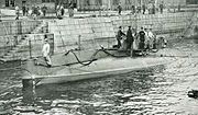 Submarine surfaced in a Japanese harbour.