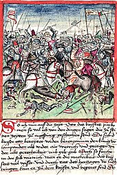 Obrázek z kroniky. Dolní polovina obsahuje text, červeně orámovaná polovina zobrazuje obrovskou a krvavou bitvu.